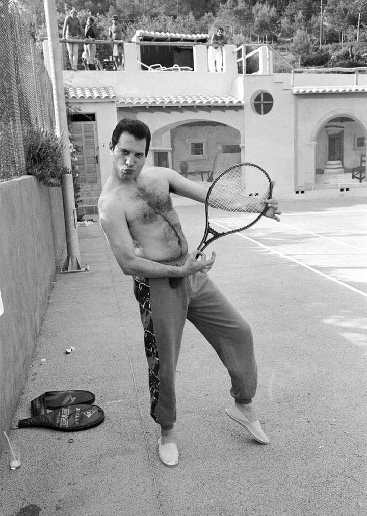 Freddie Mercury at Pikes Ibiza holding a tennis racket as if it's a guitar